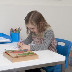 Girl drawing in kid's room